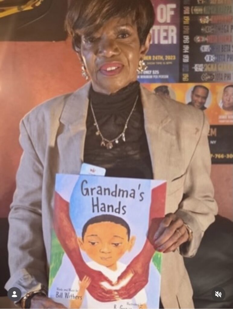 Melba Moore with her copy of Grandmas Hands Book